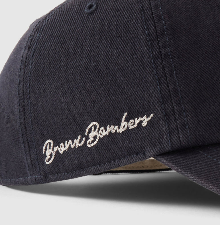 Navy blue cap with 'Bronx Bombers' embroidery on a light gray background
