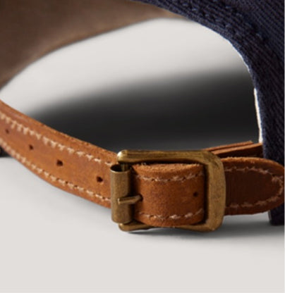 Close-up of a brown leather dog collar with a metal buckle on a white background