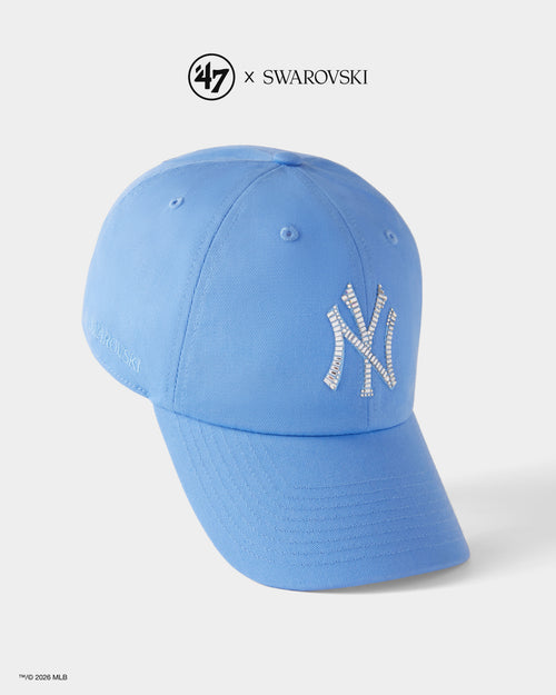 Blue baseball cap with '47' and Swarovski logos on a white background