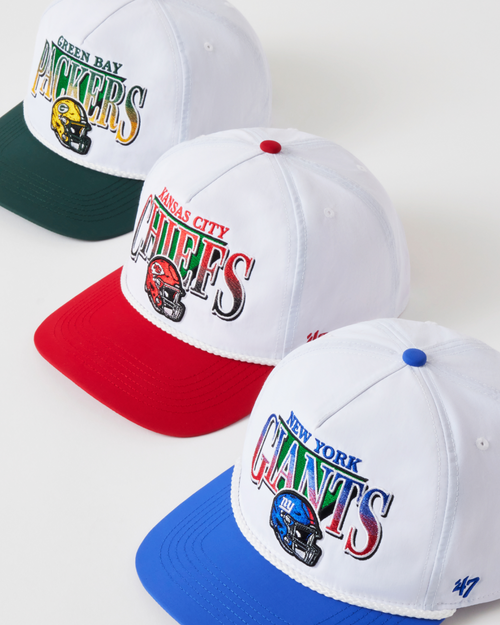 Three baseball caps with sports team logos on a white background