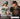 Two people wearing sports-themed hoodies and caps with NFL logos, promoting a Grandstand collection. GRANDSTAND. STYLES AS TIMELESS AS THE GAME ITSELF- SHOP THE COLLECTION.